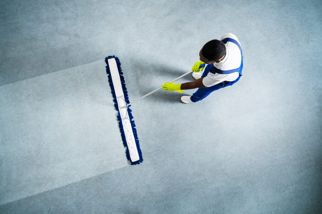 Man With Mop And Wet Floor Sign