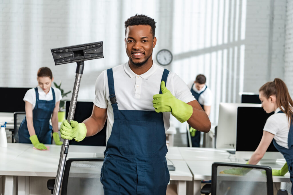 a cleaner holding a vacuum cleaner brush 