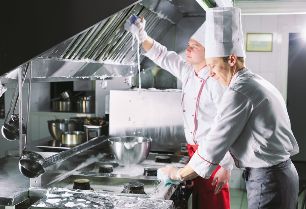 Two male cleaning the kitchen 